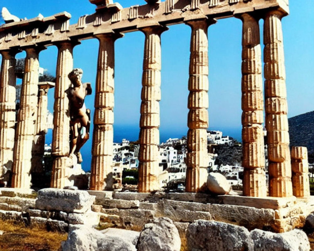 Ancient Greek temple ruins with Doric columns by the sea and town in the background