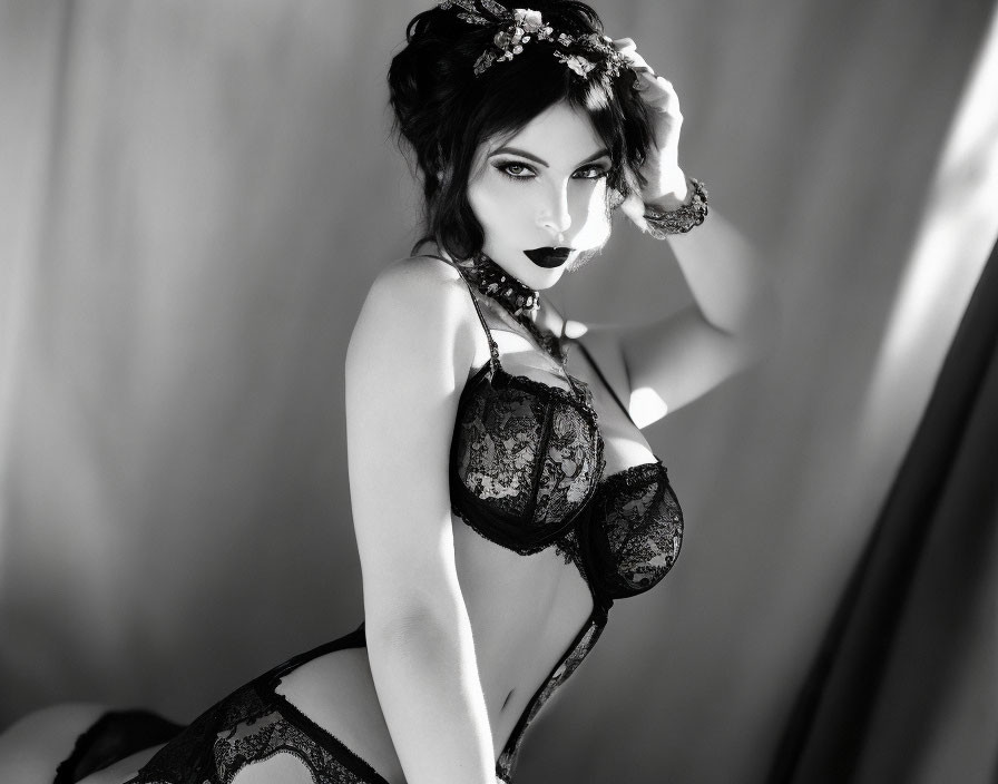 Monochrome photo of woman in lingerie with floral headpiece posing seductively