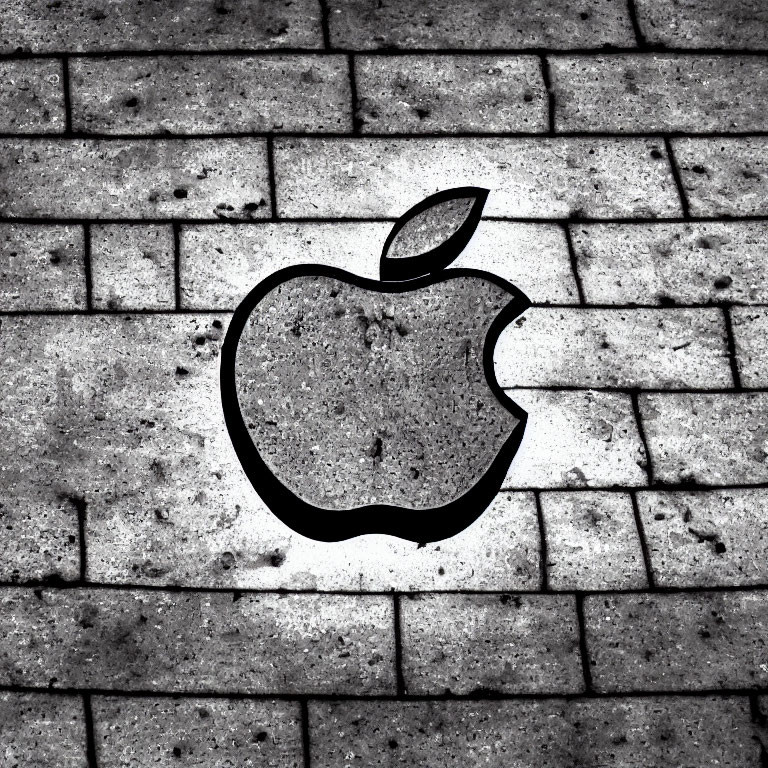 Apple logo silhouette on textured brick surface - etched shadow effect