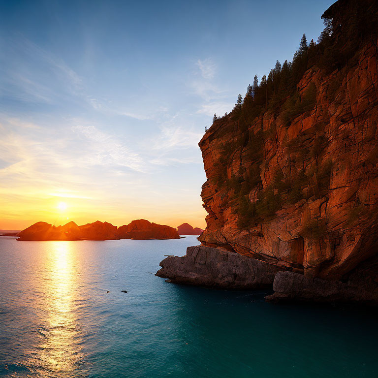 Tranquil sunset scene with golden light on rugged cliff and silhouetted islands