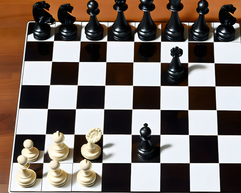 Chessboard with white and black pieces on wooden surface