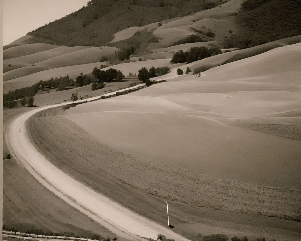 Sepia-Toned Image of Rolling Hills with Winding Road