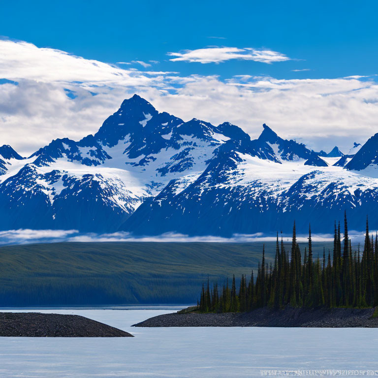 Snow-capped mountain range and serene lake landscape
