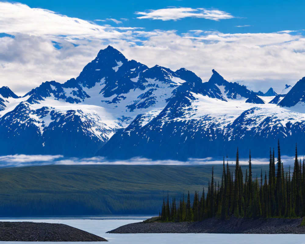 Snow-capped mountain range and serene lake landscape