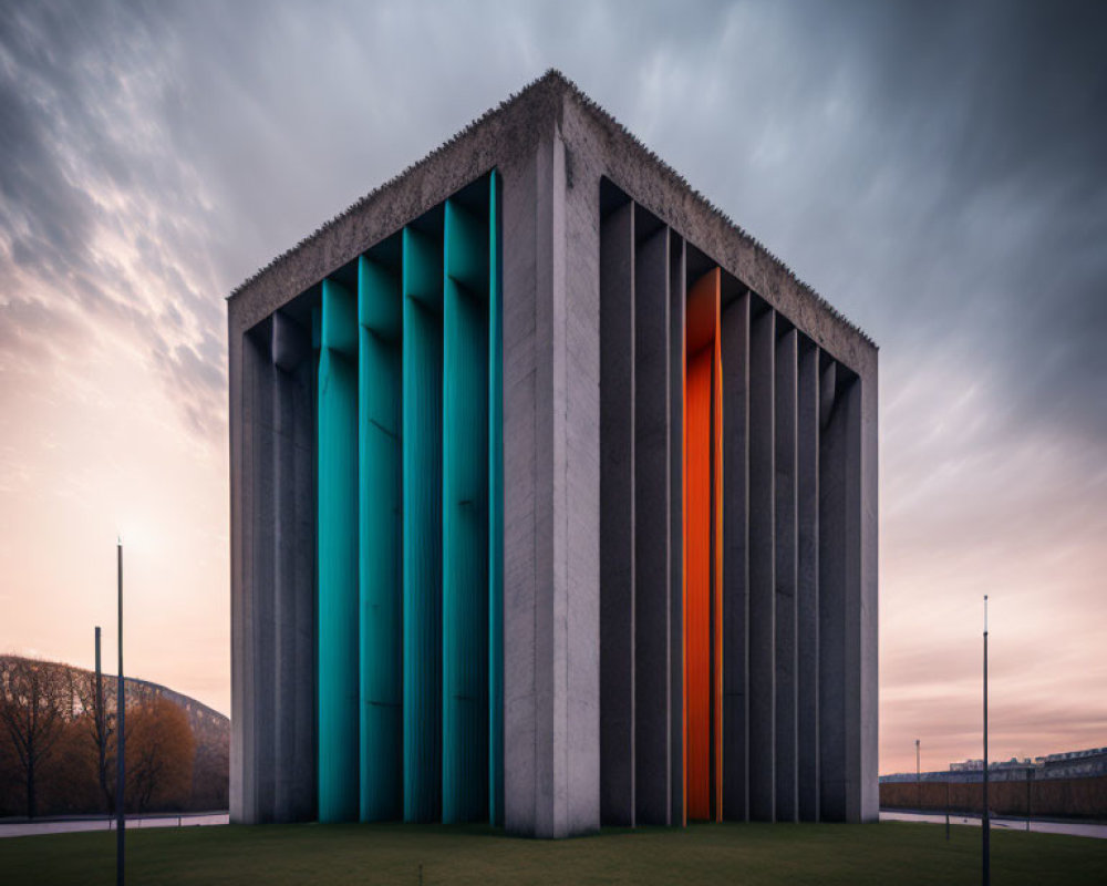 Modern Building with Blue and Orange Vertical Panels Against Dramatic Dusk Sky