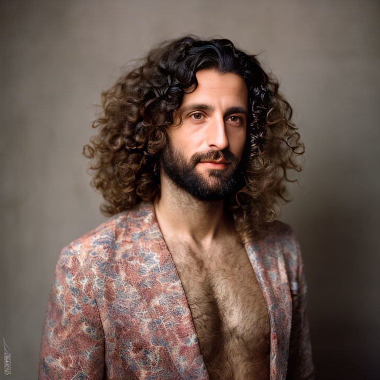 Curly-Haired Man with Beard in Paisley Jacket Portrait