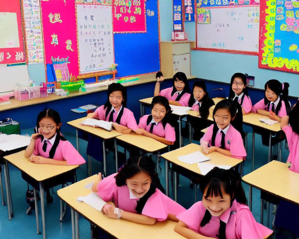 Smiling students in pink uniforms in a classroom with educational posters