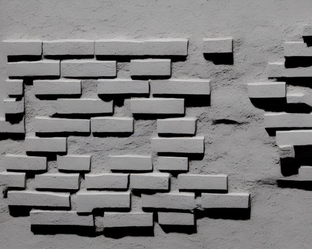 Sporadic white bricks on textured grey wall with shadows