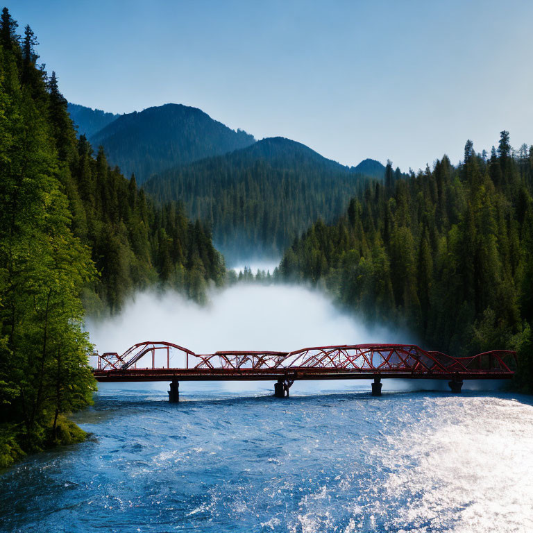 Red bridge over misty river with tree-covered hills under blue sky