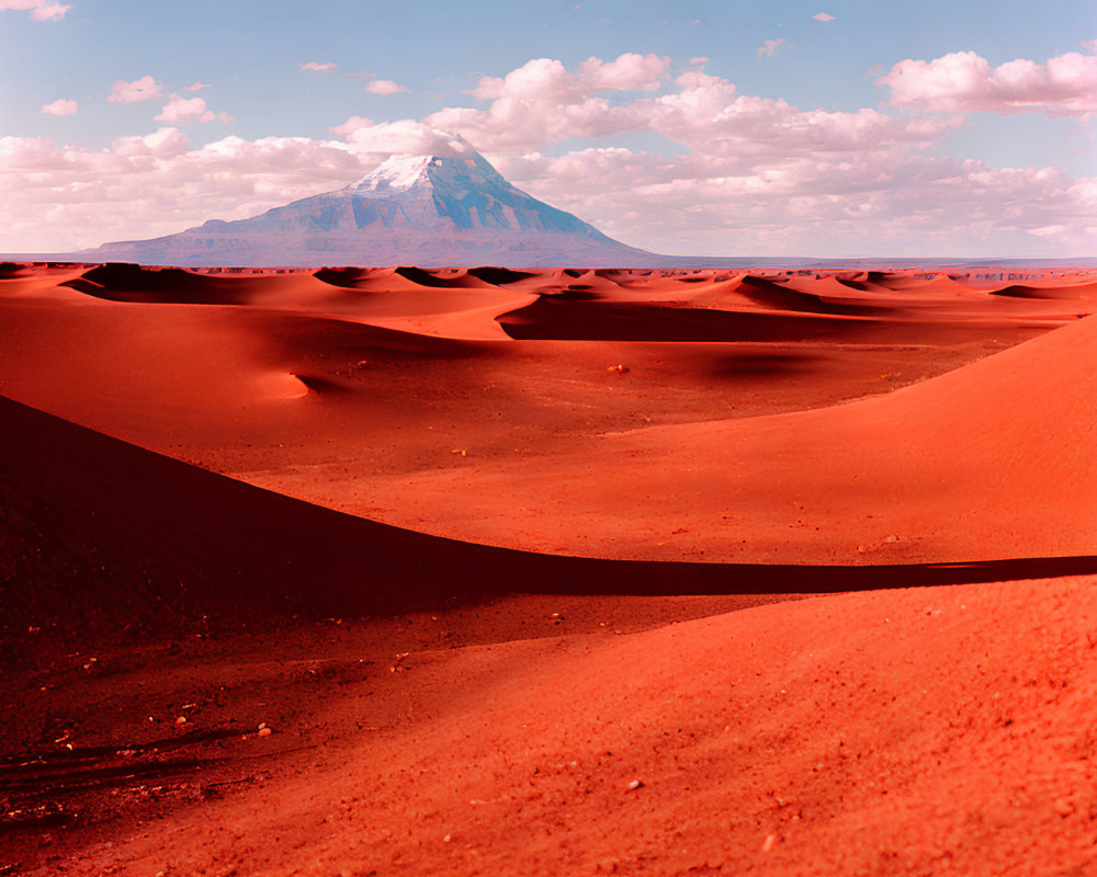 Scenic red sand desert with dunes and mountain landscape