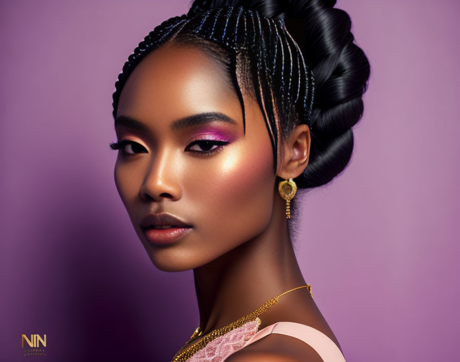 Elaborate braids and bold makeup on woman against purple background