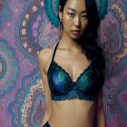 Woman in Teal Lace Lingerie Poses with Ornate Paisley Backdrop