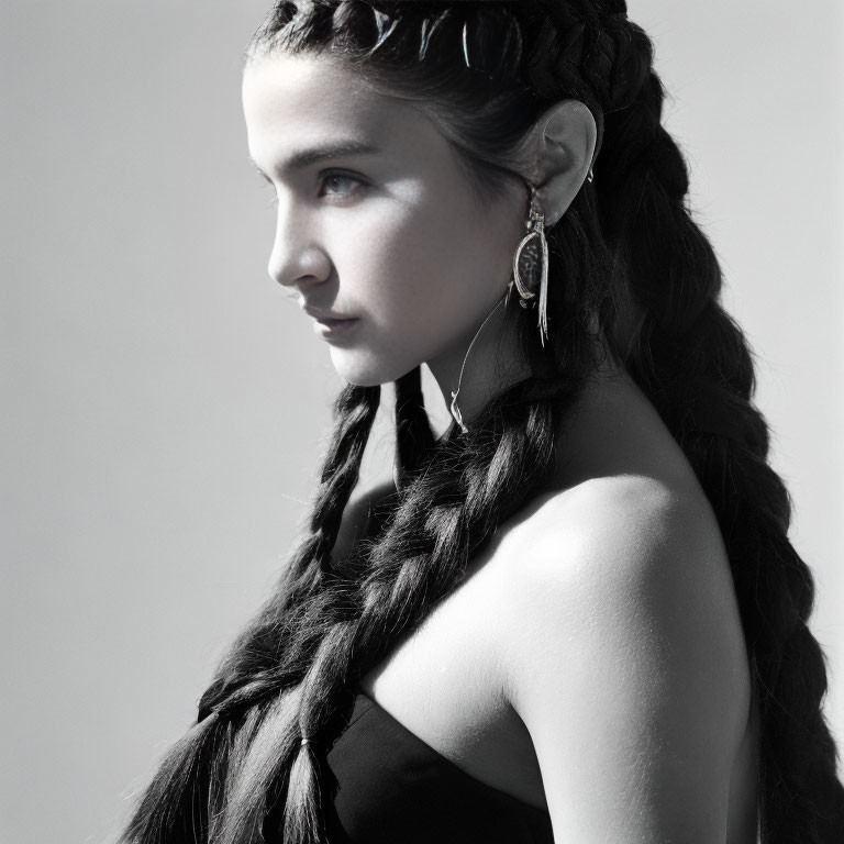 Monochrome portrait of woman with braided hair and earring