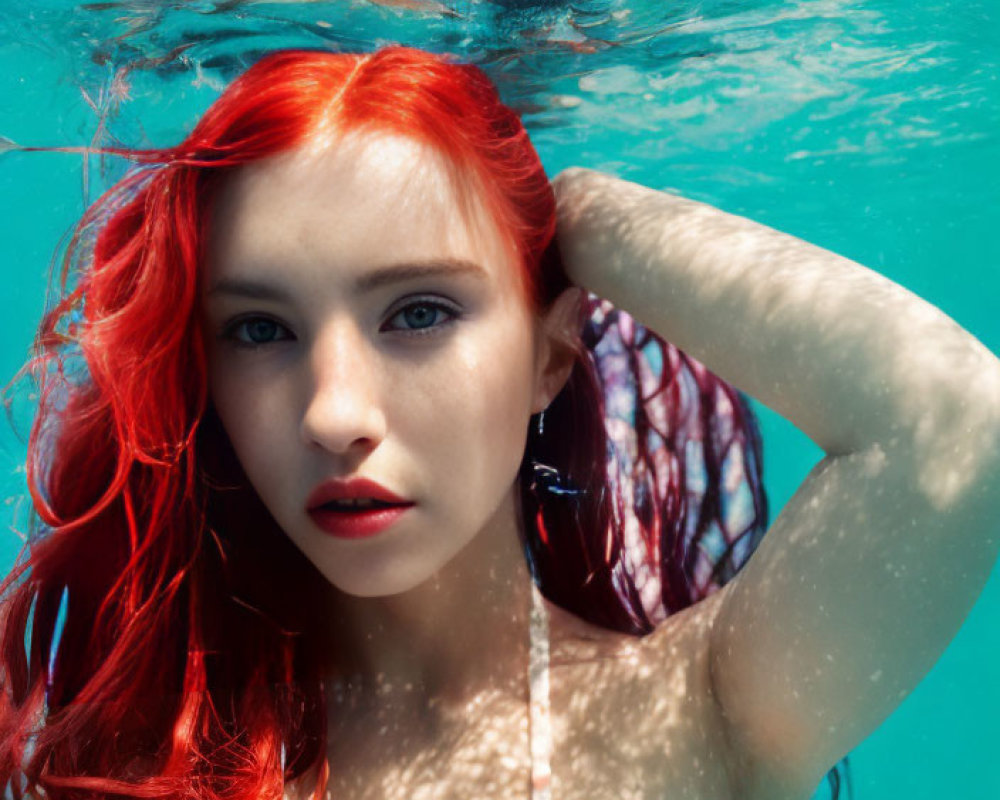 Red-haired woman partially submerged in blue water
