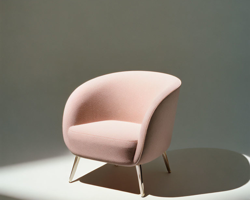 Pink Upholstered Chair with Curved Backrest and Metal Legs in Natural Light