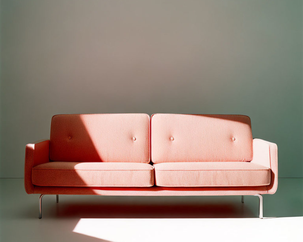 Minimalistic Coral Pink Sofa with Metal Legs on Neutral Background