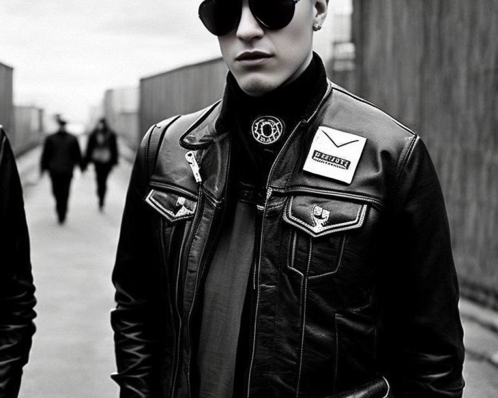 Monochrome image of a man in leather jacket and aviator sunglasses