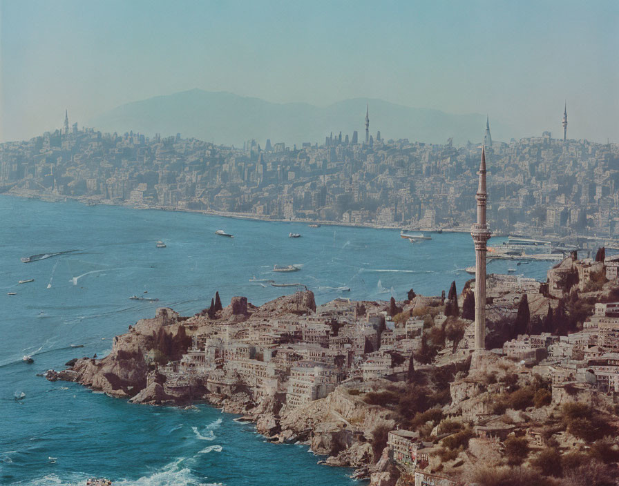 Coastal city panorama with mosque minaret, boats, and urban skyline under hazy sky