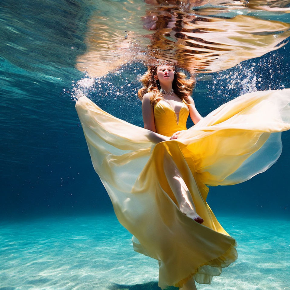 Woman in Yellow Dress Floating Underwater with Sunlight Filtering