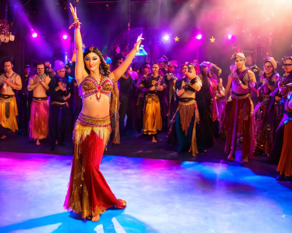 Female dancer in bejeweled costume leads vibrant belly dance on stage