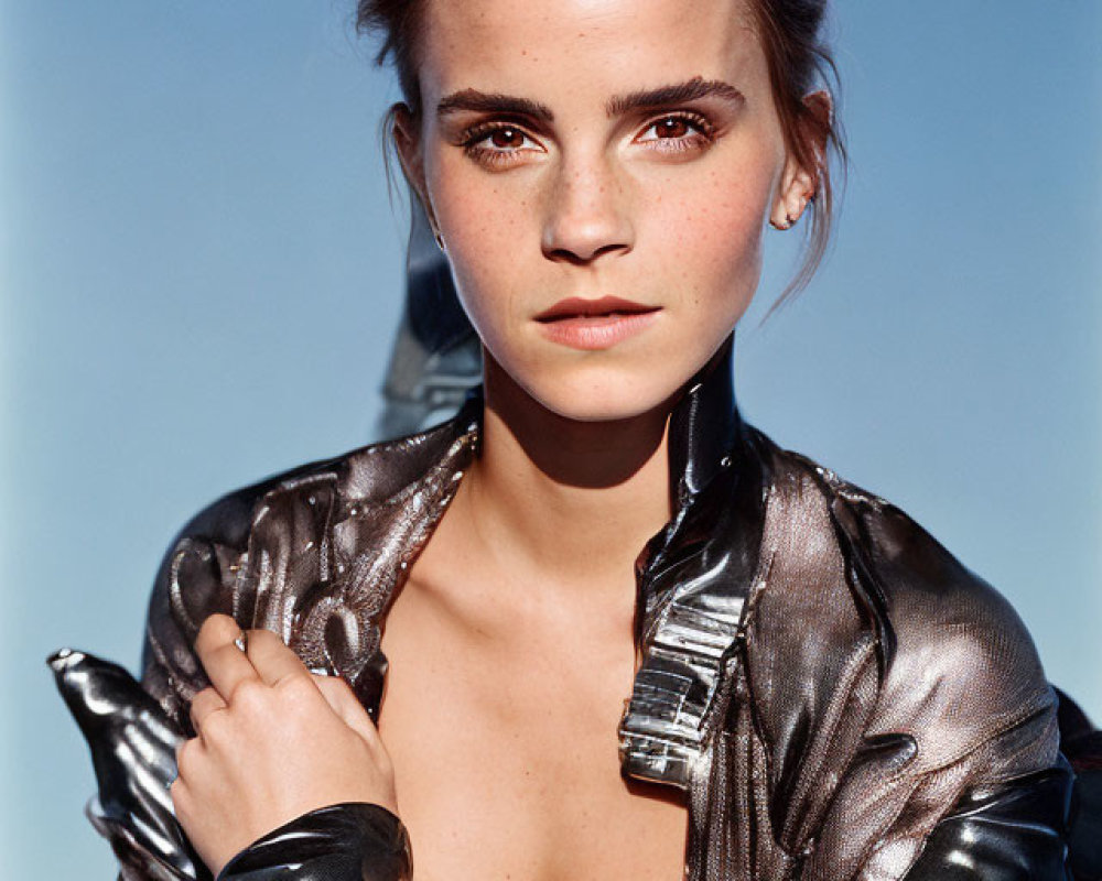 Freckled woman in metallic jacket against blue sky