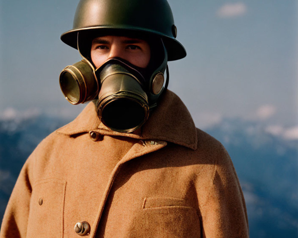 Military person in helmet and gas mask against mountain backdrop in brown overcoat