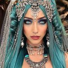 Person with Blue Eyes and Teal Hair in Ornate Gold Headdress