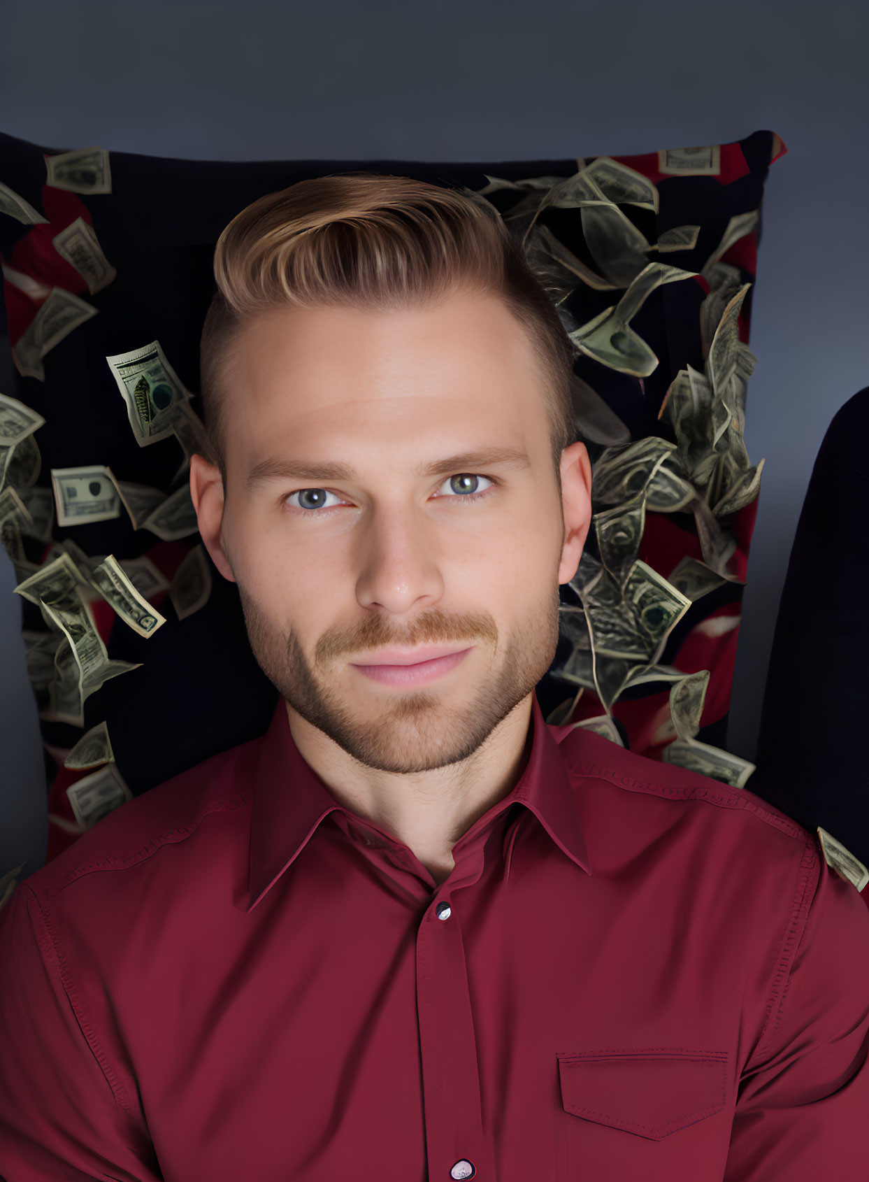 Blond man with beard in red shirt surrounded by flying dollar bills