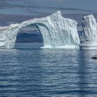 Three Large Icebergs on Rippled Blue Sea at Dusk