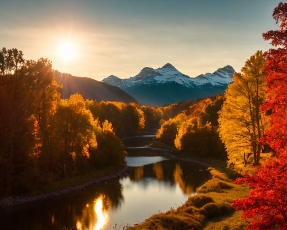 Scenic sunset over river in autumn forest with snow-capped mountains