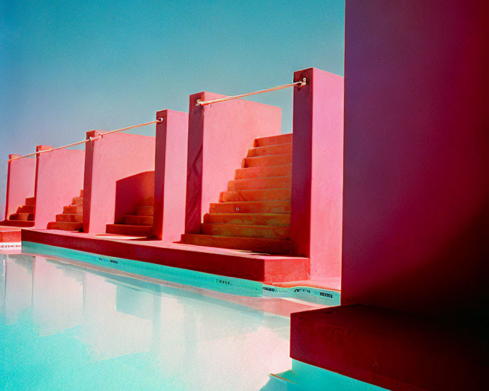 Vibrant pink staircases by tranquil turquoise pool under blue sky