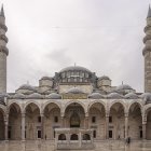 Ornate mosque with domes and minarets by water