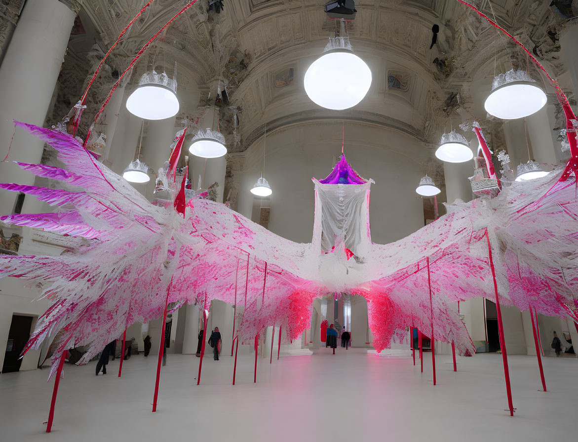 Vibrant pink wing installation in elegant white interior