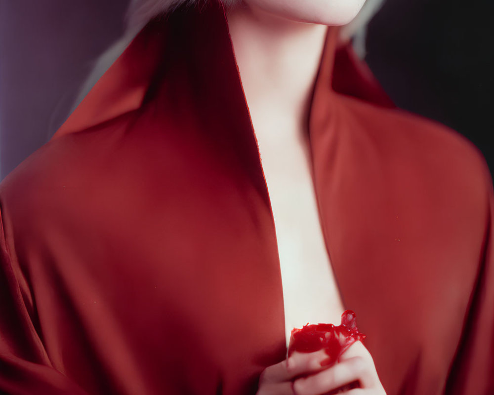 Platinum Blonde Person in Red Lipstick and Satin Garment Holding Object