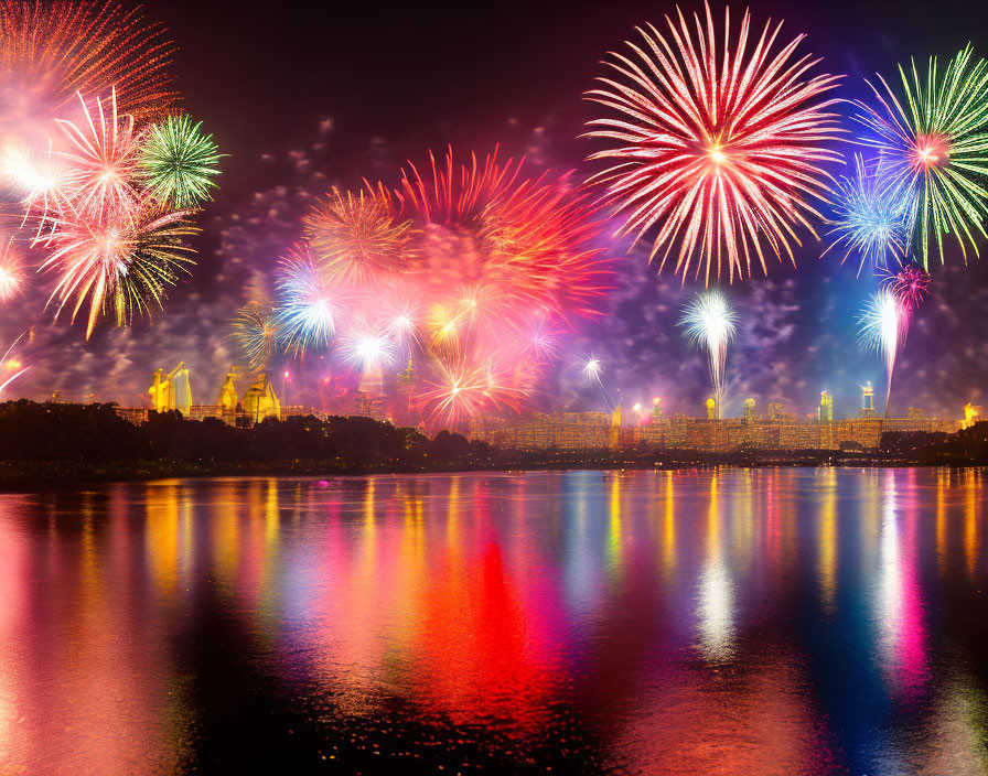 Colorful fireworks illuminate cityscape and water at night