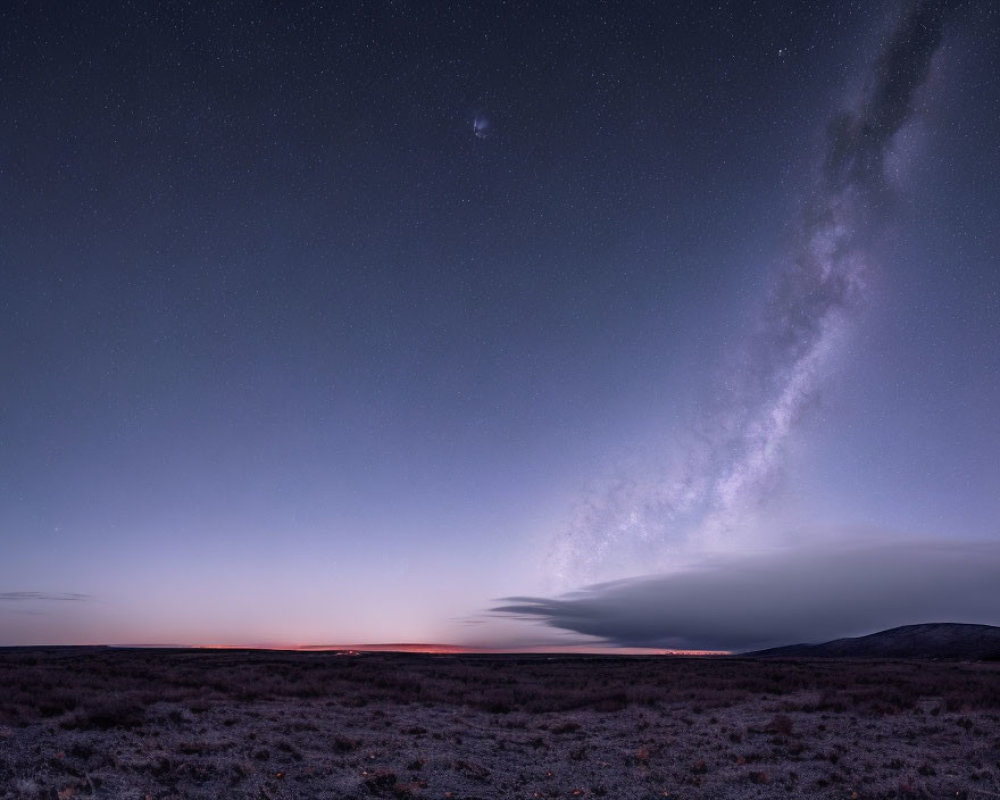Twilight sky with Milky Way over deserted landscape at sunset