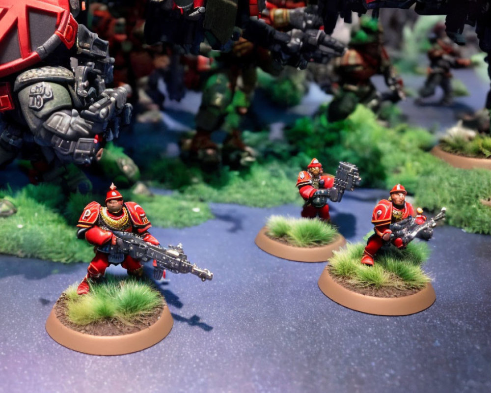 Futuristic red-armored soldier miniatures on grassy diorama with robotic suits