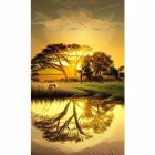 Tranquil sunset scene with golden hues and tree silhouette reflected in water