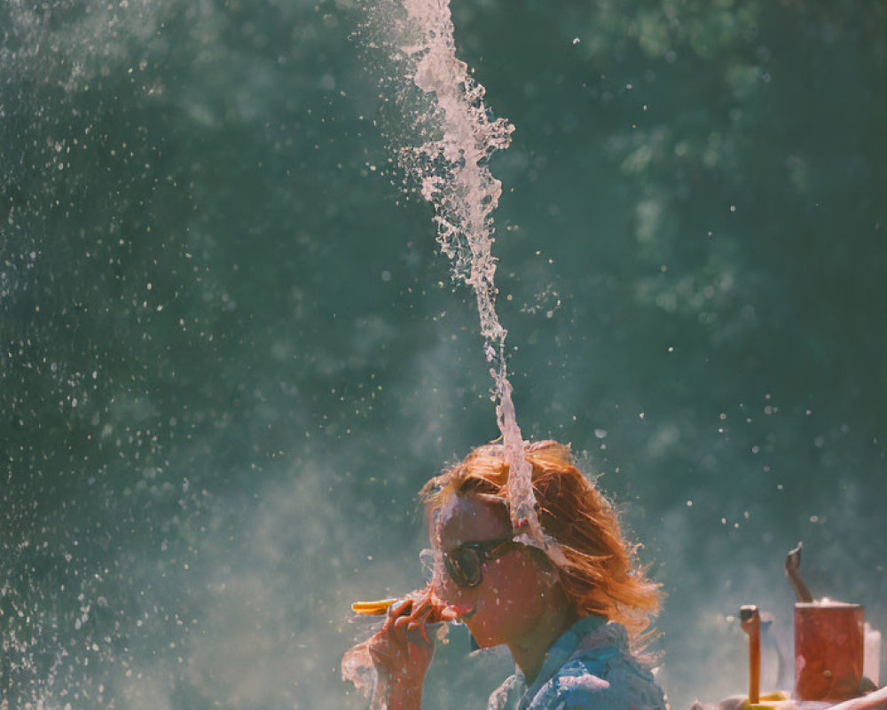 Woman in sunglasses sitting behind water jet with sunlight and cigarette.