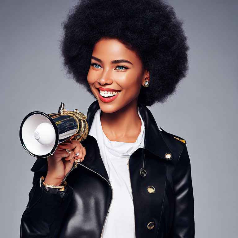 Woman with Afro Smiles Holding Megaphone in Leather Jacket