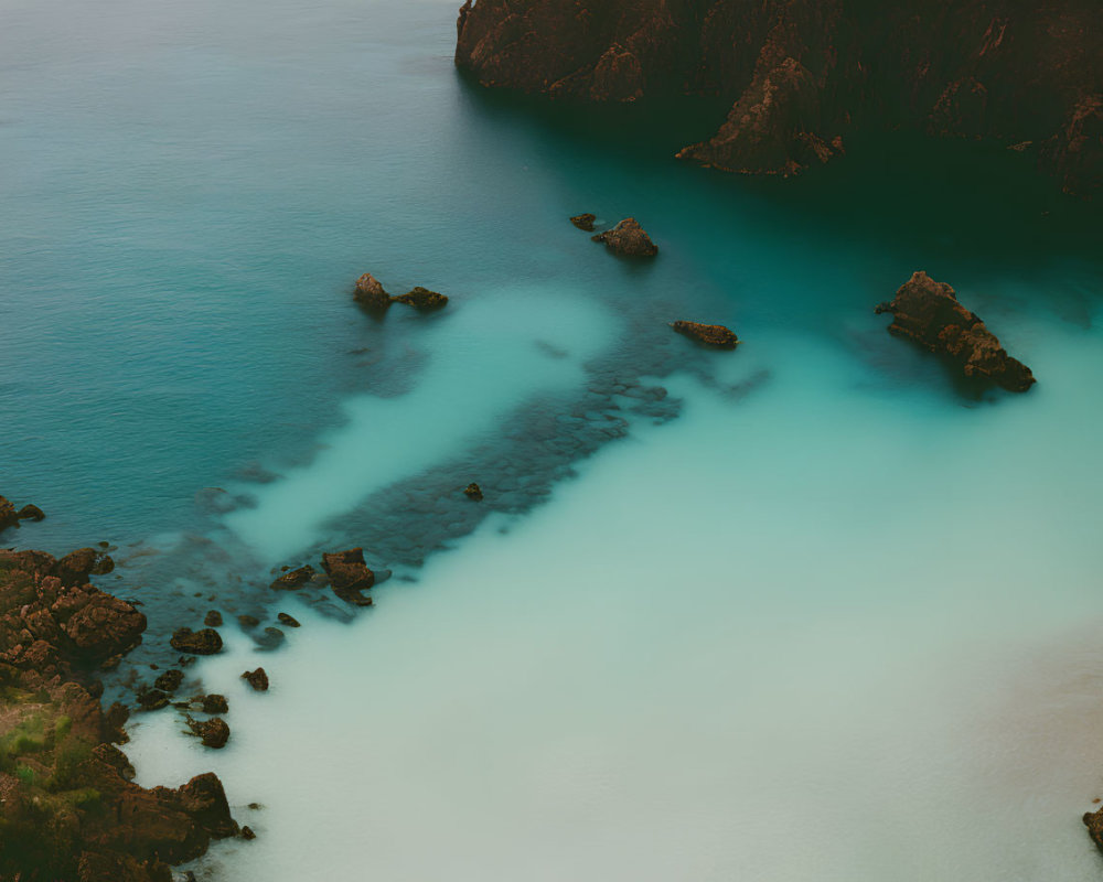 Turquoise Waters and Rocky Cliffs in Coastal Aerial View