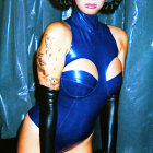 Model in Blue Bodysuit with Dramatic Makeup and Arm Accessories