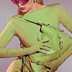 Vibrant pink hair and olive bodysuit on futuristic woman against purple backdrop