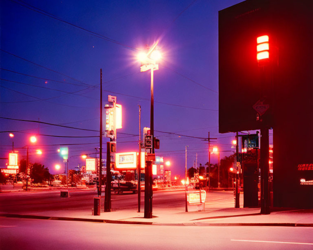 Desolate cityscape with illuminated streetlights and signage at night