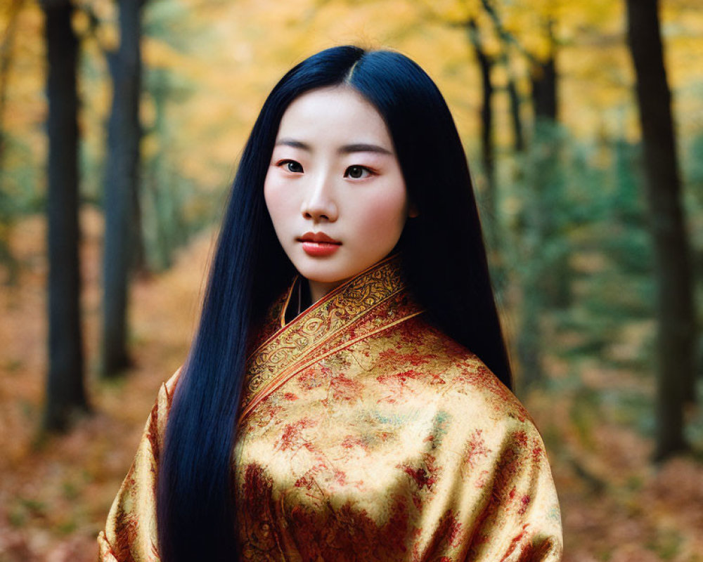 Woman in traditional attire with long black hair in autumn forest
