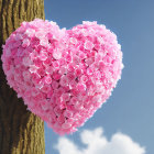 Heart-shaped pink flower wreath on tree trunk under clear blue sky