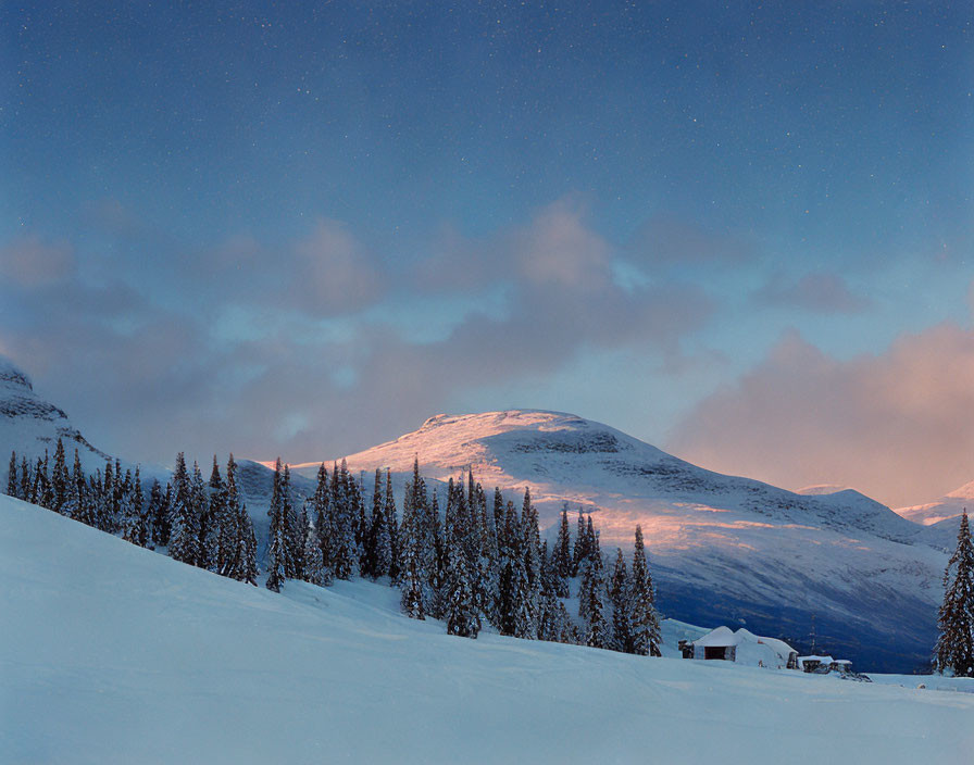 Snowy Landscape at Dusk with Glowing Mountain Peak