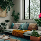 Plant-filled cozy corner with tropical sofa and coffee table