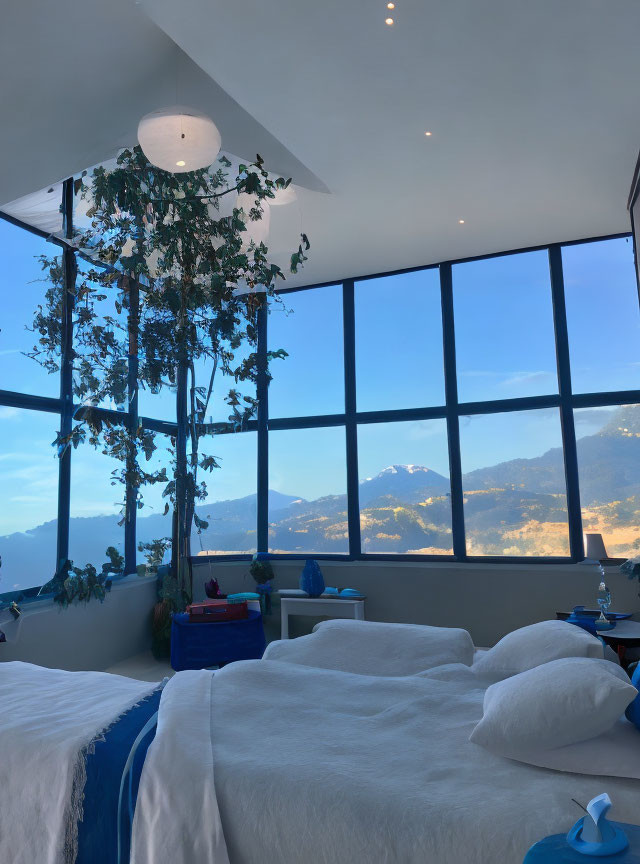 Bedroom with panoramic mountain view and indoor greenery décor