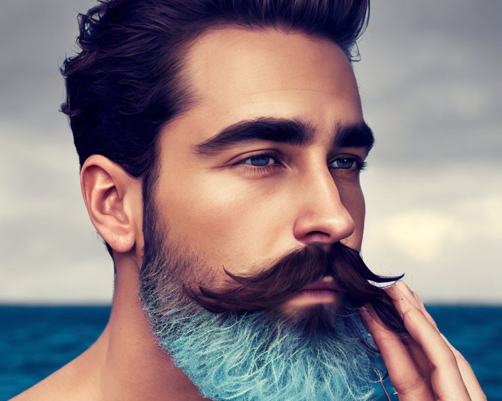 Man with Sculpted Facial Hair and Blue Ombre Beard in Stormy Sea Setting